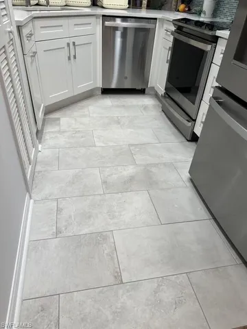 a kitchen with a stove top oven and cabinets