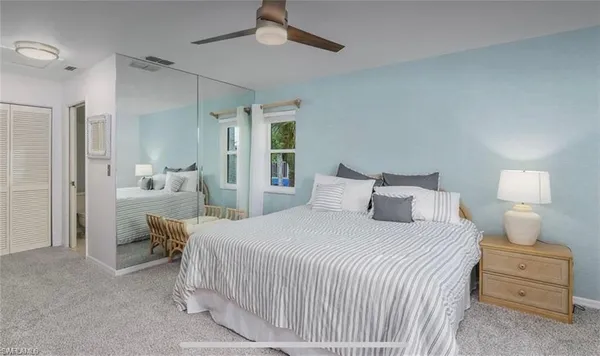 a bedroom with a bed and a lamp