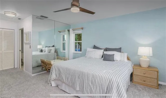 a bedroom with a bed and a lamp