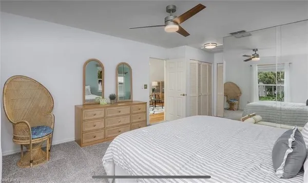 a bedroom with a bed and a chair