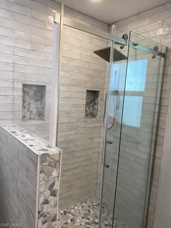 a bathroom with a shower and a sink