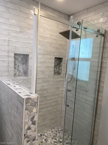a bathroom with a shower and a sink
