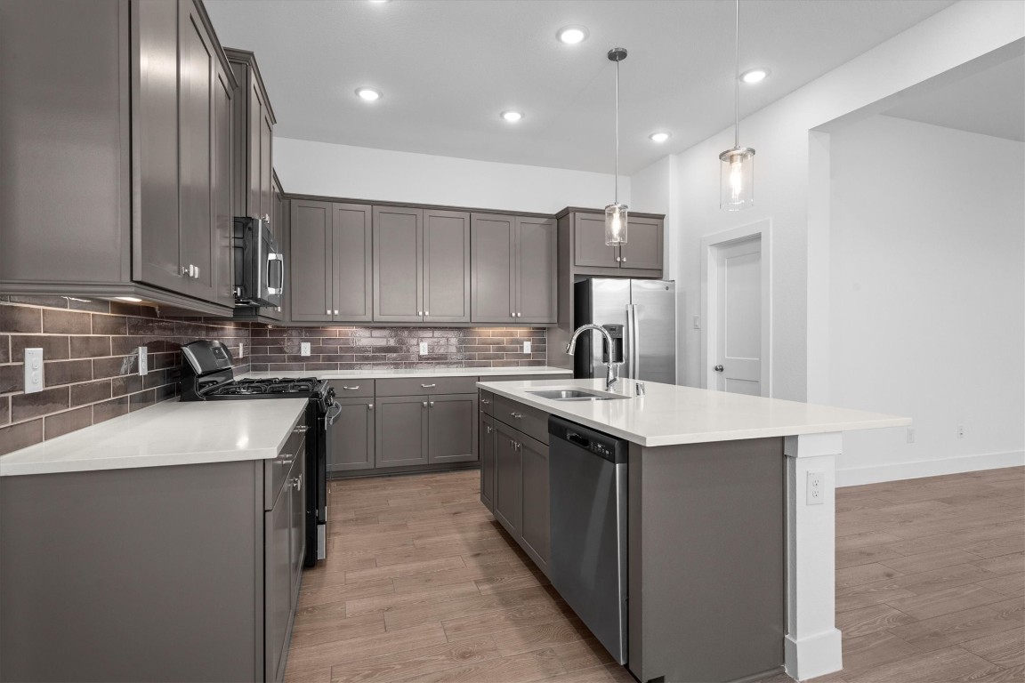 120 Red Cascade Trail Willis, TX 77318 - Photo 12 of 37 a kitchen with a sink stainless steel appliances and cabinets