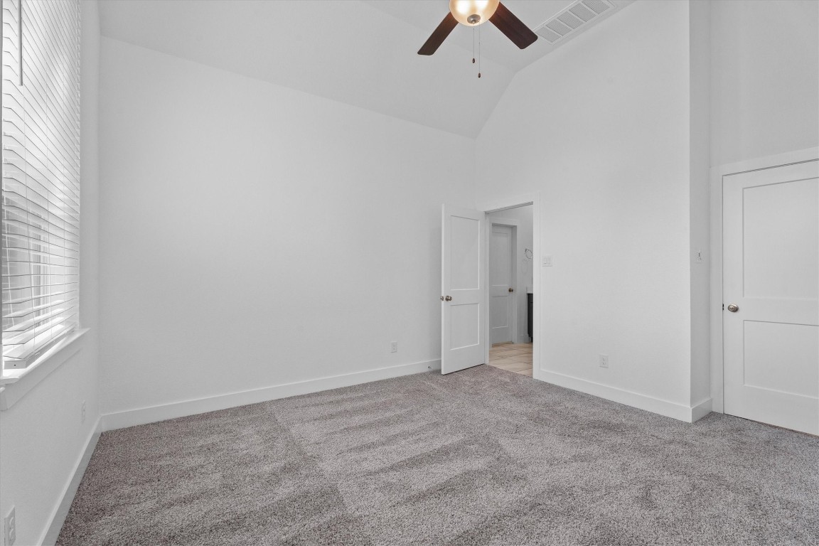 120 Red Cascade Trail Willis, TX 77318 - Photo 22 of 37 an empty room with ceiling fan and window