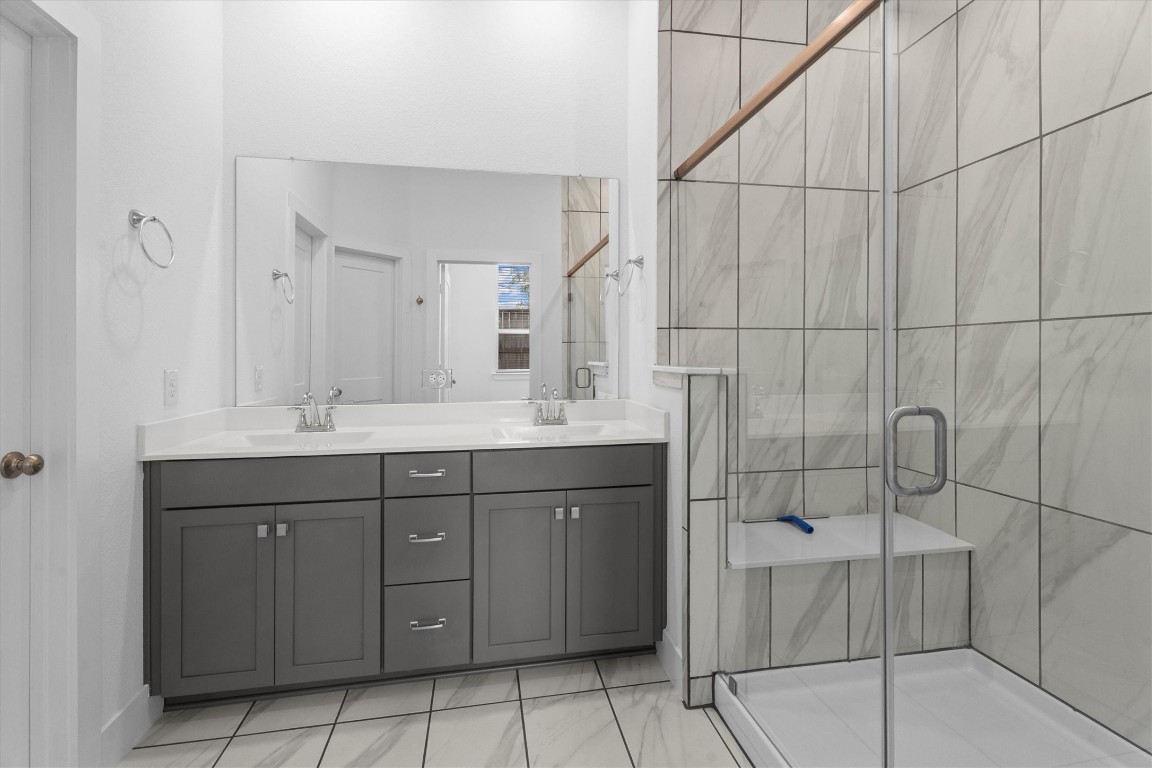 120 Red Cascade Trail Willis, TX 77318 - Photo 25 of 37 a bathroom with a double vanity sink and mirror