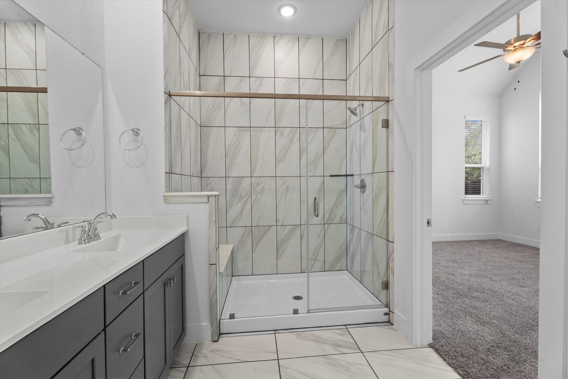 120 Red Cascade Trail Willis, TX 77318 - Photo 26 of 37 a bathroom with a shower sink and mirror