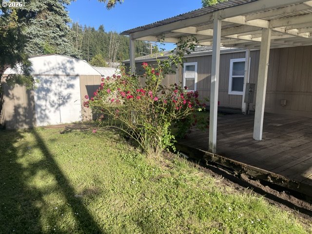 5660 Daisy Street, Unit 31 Springfield, OR 97478 - Photo 13 of 44 a view of a house with a small yard and a large tree