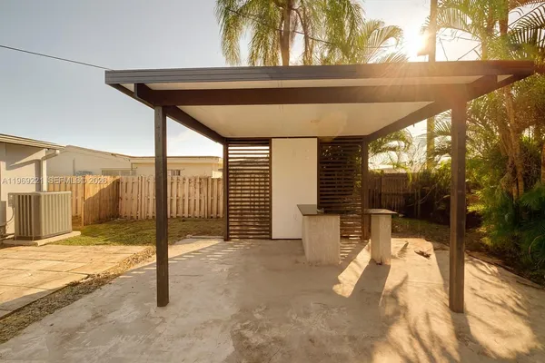 a backyard of a house with table and chairs