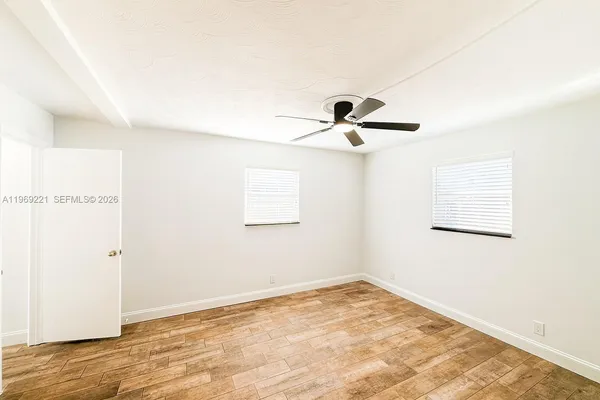 a view of a room with a empty space and a window