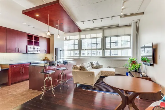 a living room with furniture a dining table and kitchen view