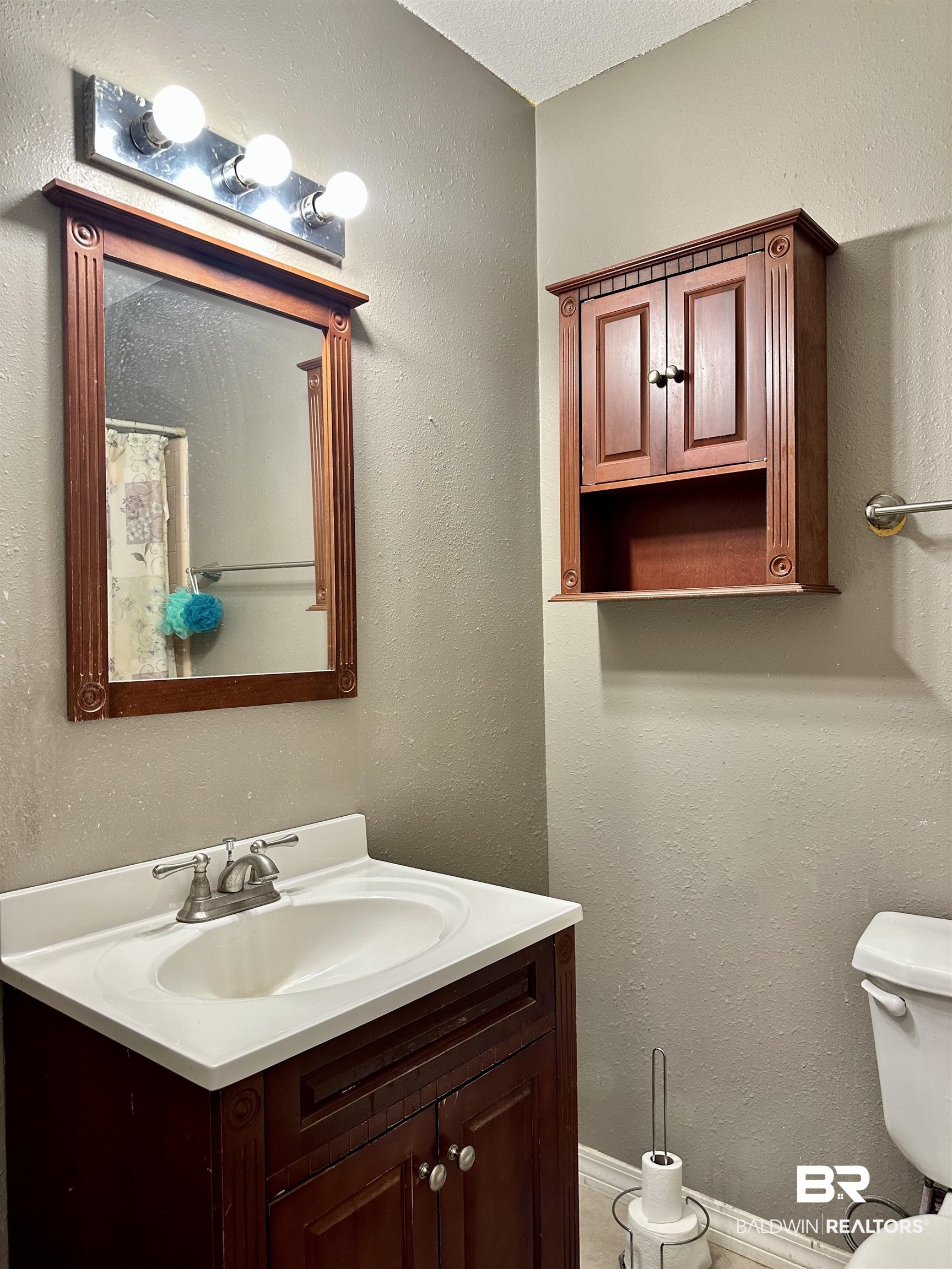 2593 Foshee Road Brewton, AL 36426 - Photo 10 of 15 Bathroom featuring vanity, a textured ceiling, and toilet