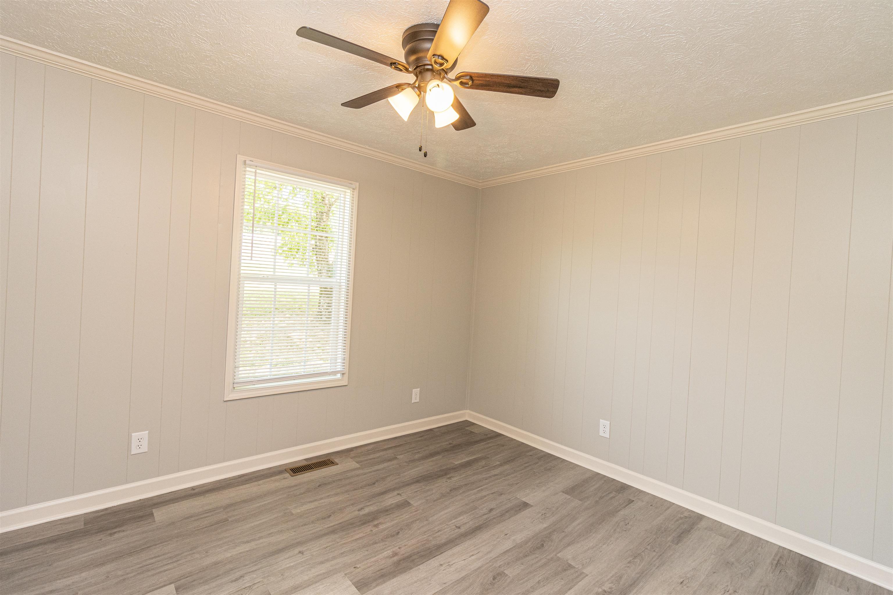3532 Ramer Selmer Road Ramer, TN 38367 - Photo 12 of 15 an empty room with wooden floor and windows