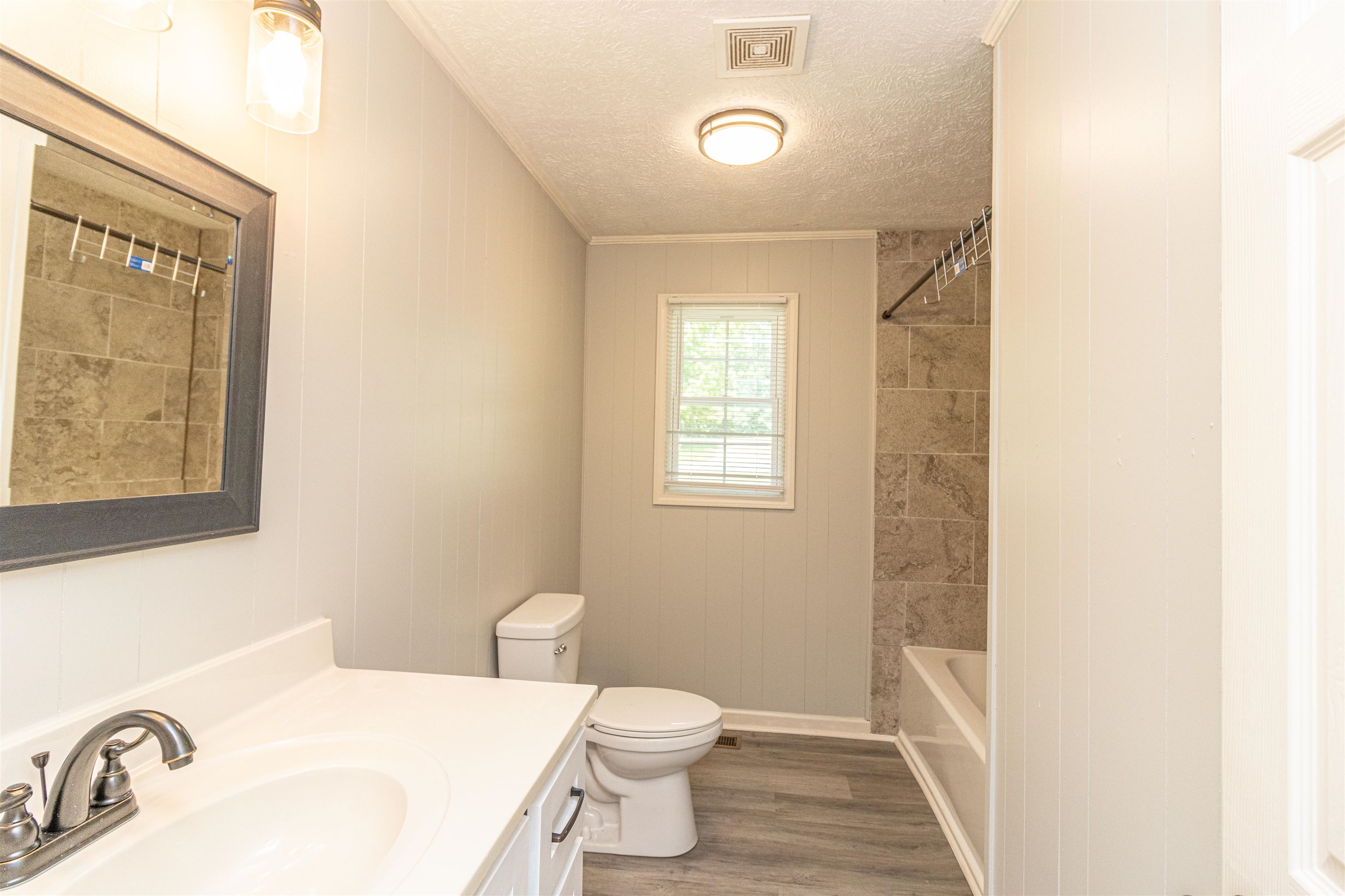 3532 Ramer Selmer Road Ramer, TN 38367 - Photo 13 of 15 a white toilet sitting next to a bathroom sink