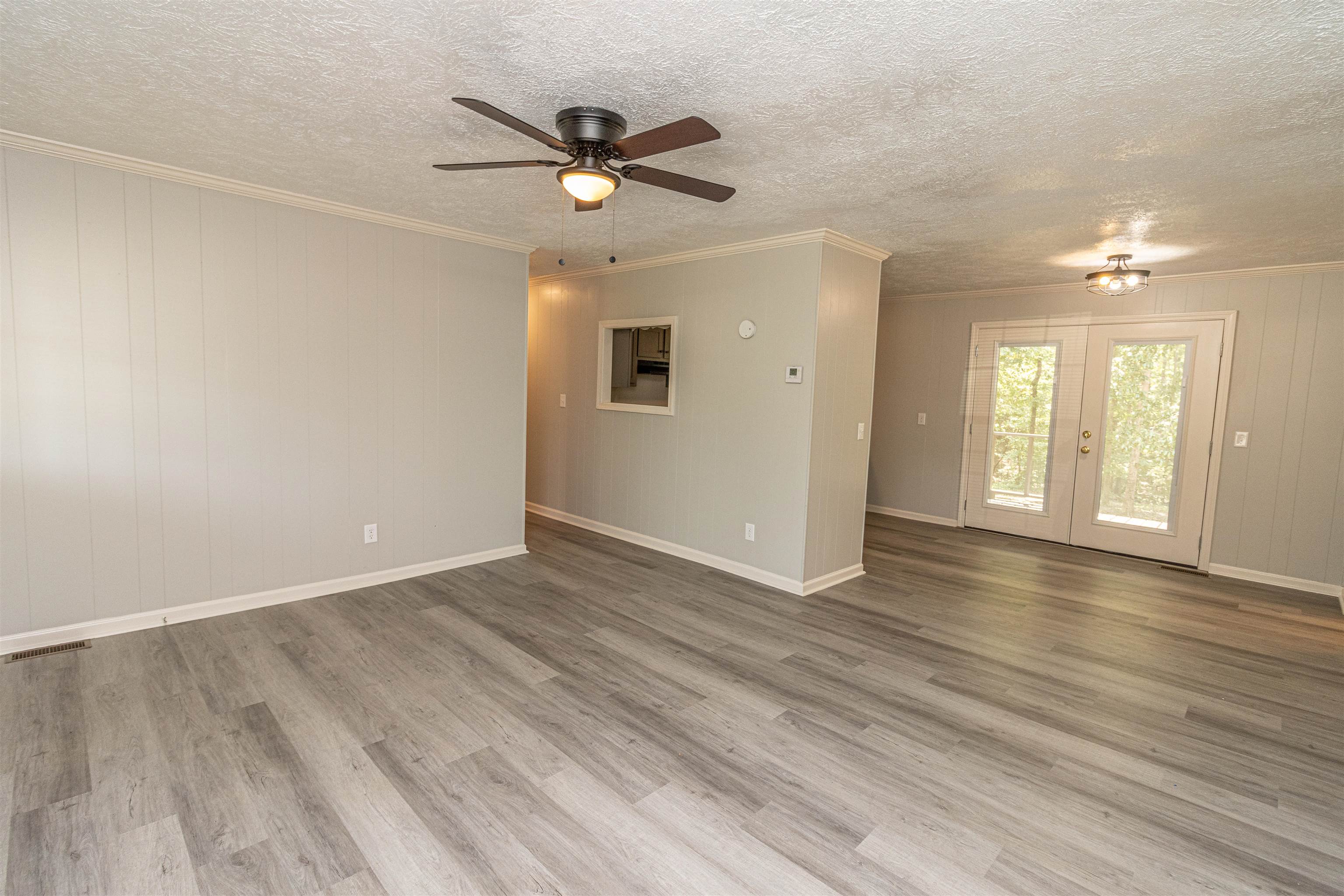 3532 Ramer Selmer Road Ramer, TN 38367 - Photo 5 of 15 an empty room with wooden floor fan and windows
