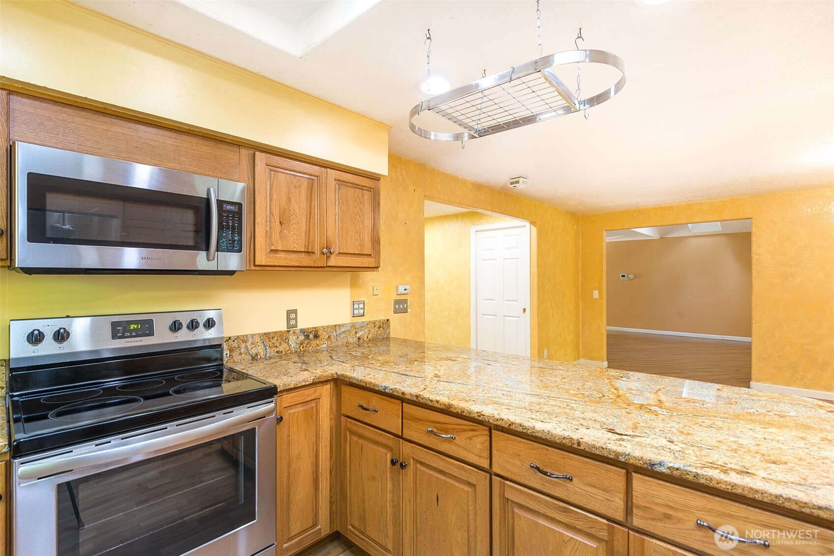 123 Forest Ridge Drive Sequim, WA 98382 - Photo 18 of 32 a kitchen with stainless steel appliances a stove a sink and a microwave