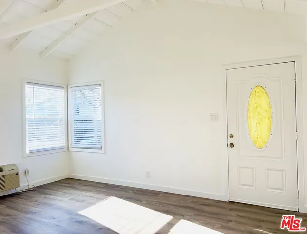 a view of a kitchen with a sink and dishwasher with wooden floor