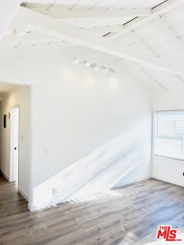 a view of a room with wooden floor and window