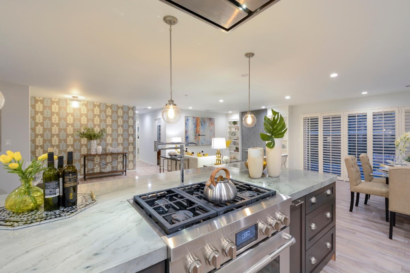 10166 Bonny Drive Cupertino, CA 95014 - Photo 12 of 46 a kitchen with stainless steel appliances granite countertop a stove a sink and a wooden floors
