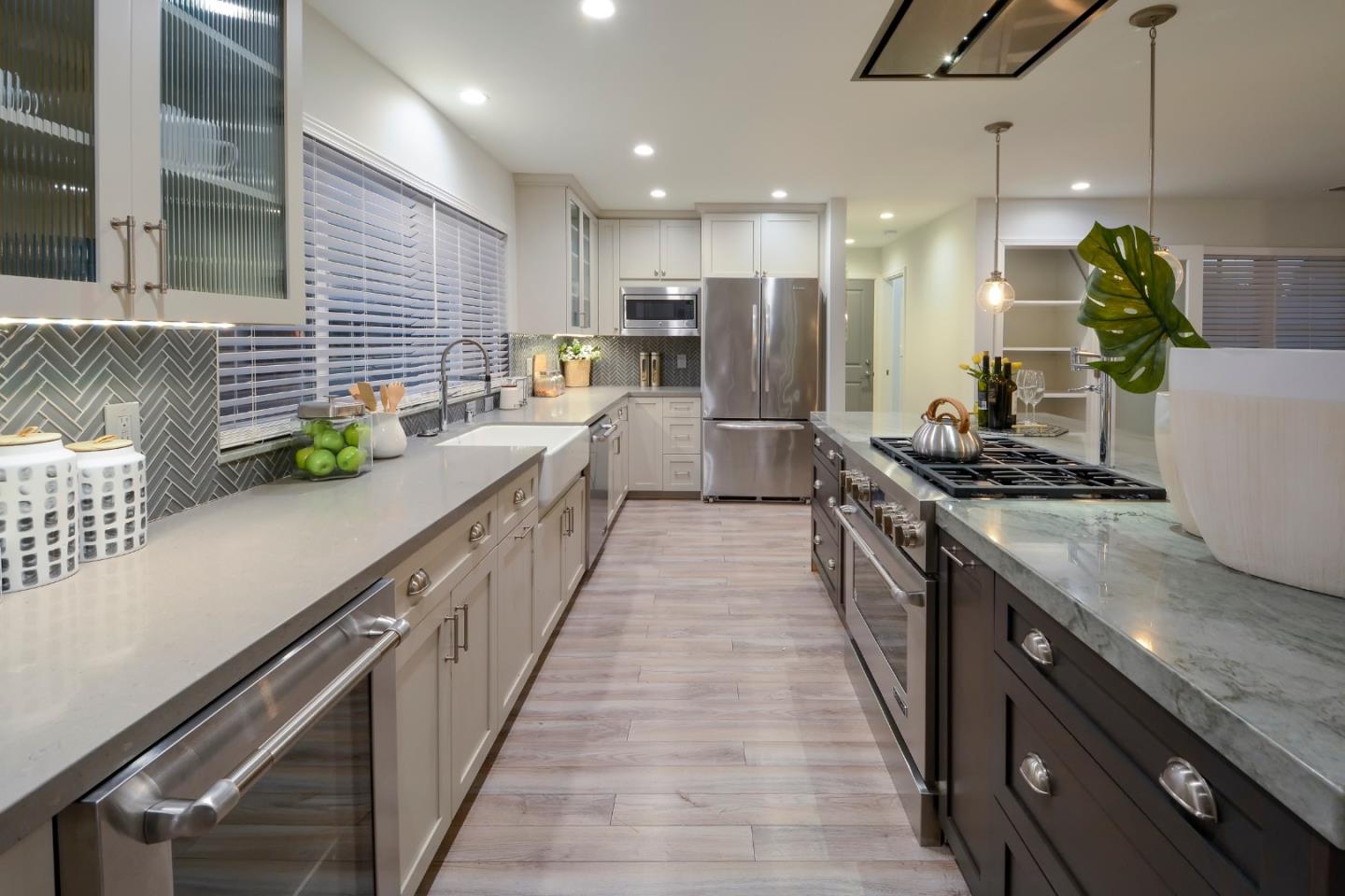 10166 Bonny Drive Cupertino, CA 95014 - Photo 13 of 46 a large kitchen with lots of counter space and stainless steel appliances
