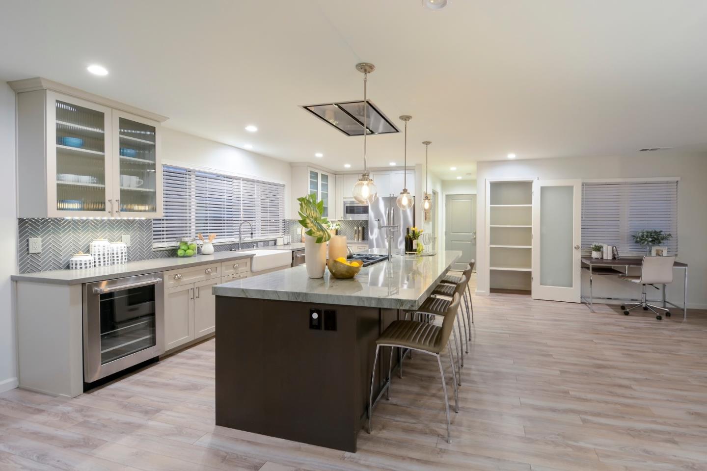 10166 Bonny Drive Cupertino, CA 95014 - Photo 16 of 46 a kitchen with stainless steel appliances granite countertop a sink a stove and a wooden floors