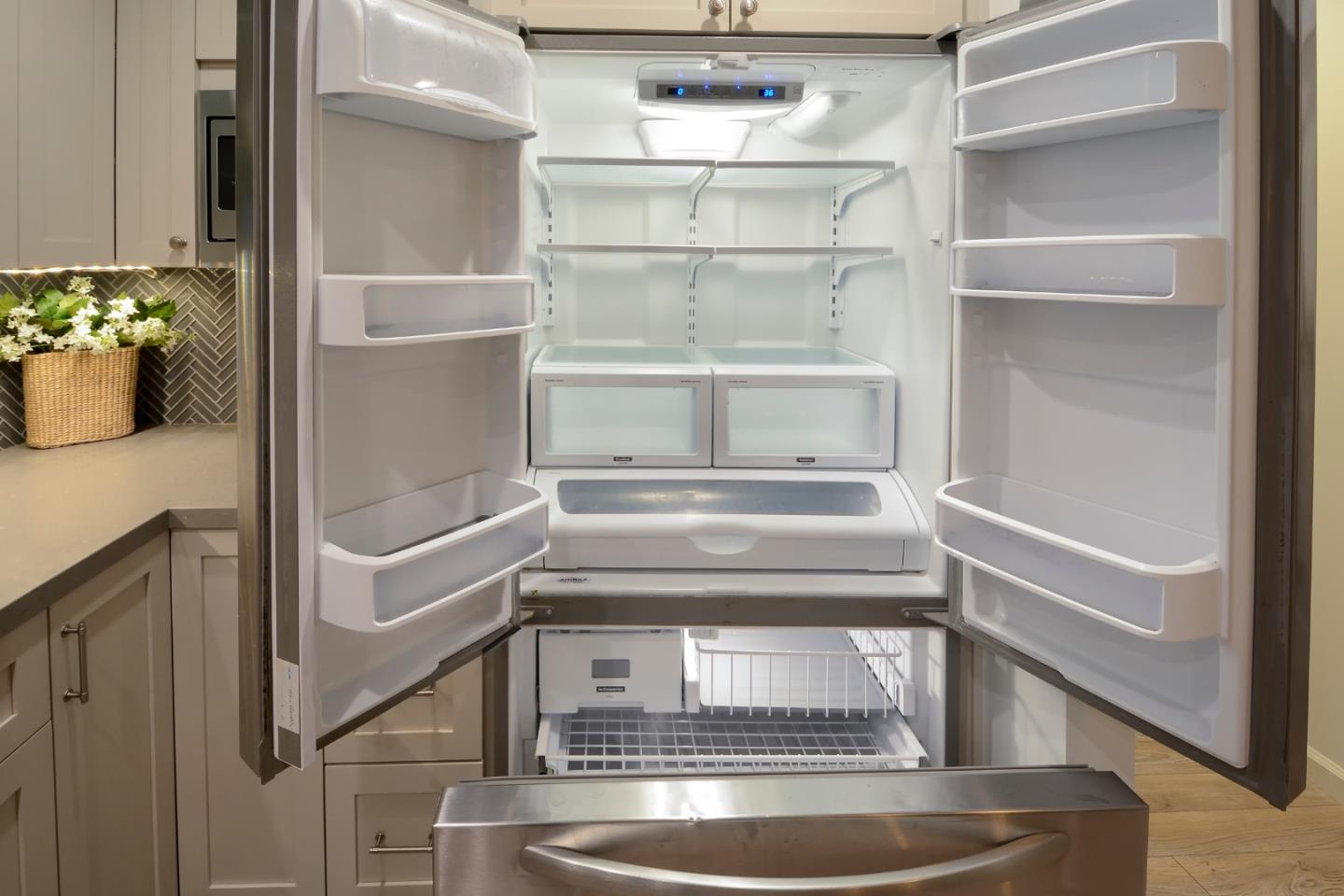 10166 Bonny Drive Cupertino, CA 95014 - Photo 18 of 46 a refrigerator freezer sitting inside of a kitchen