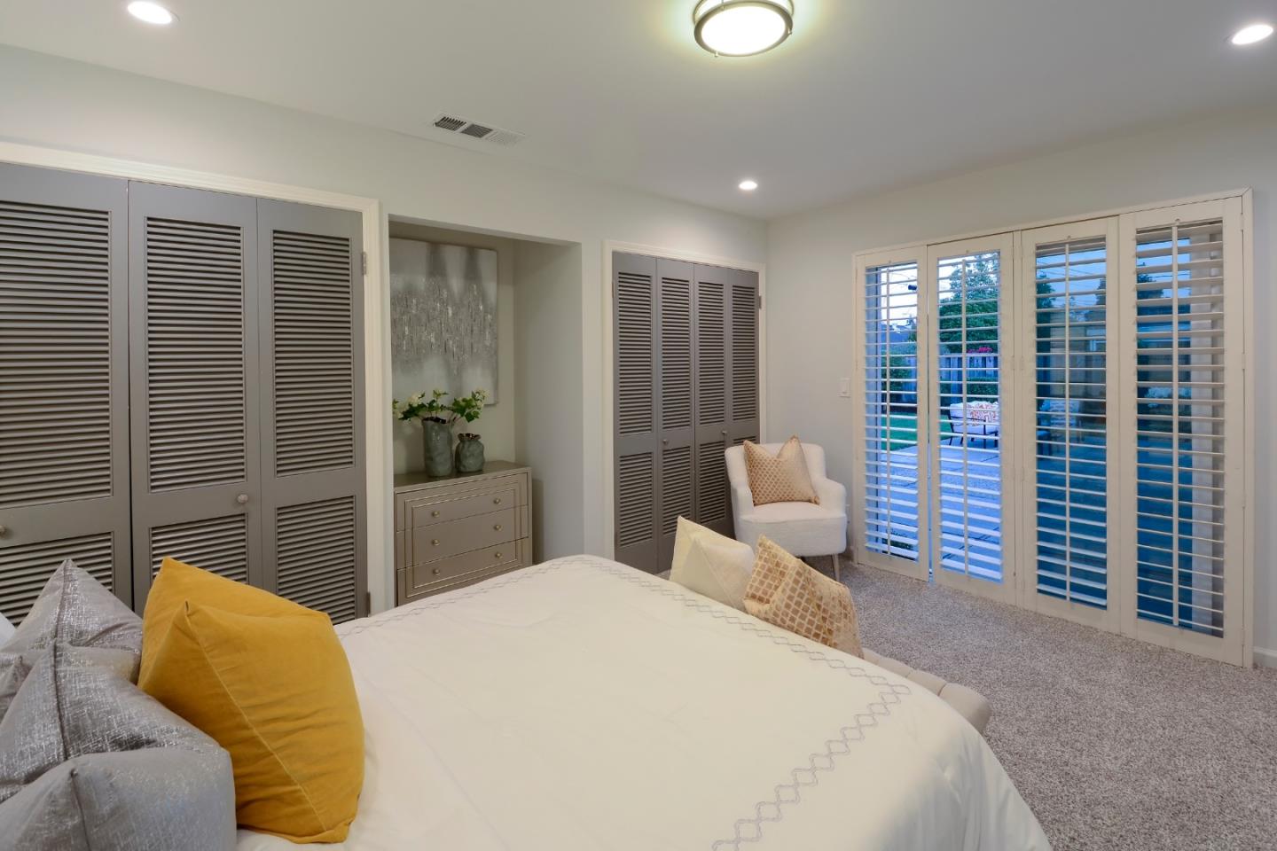 10166 Bonny Drive Cupertino, CA 95014 - Photo 19 of 46 a bedroom with a large bed and a large window