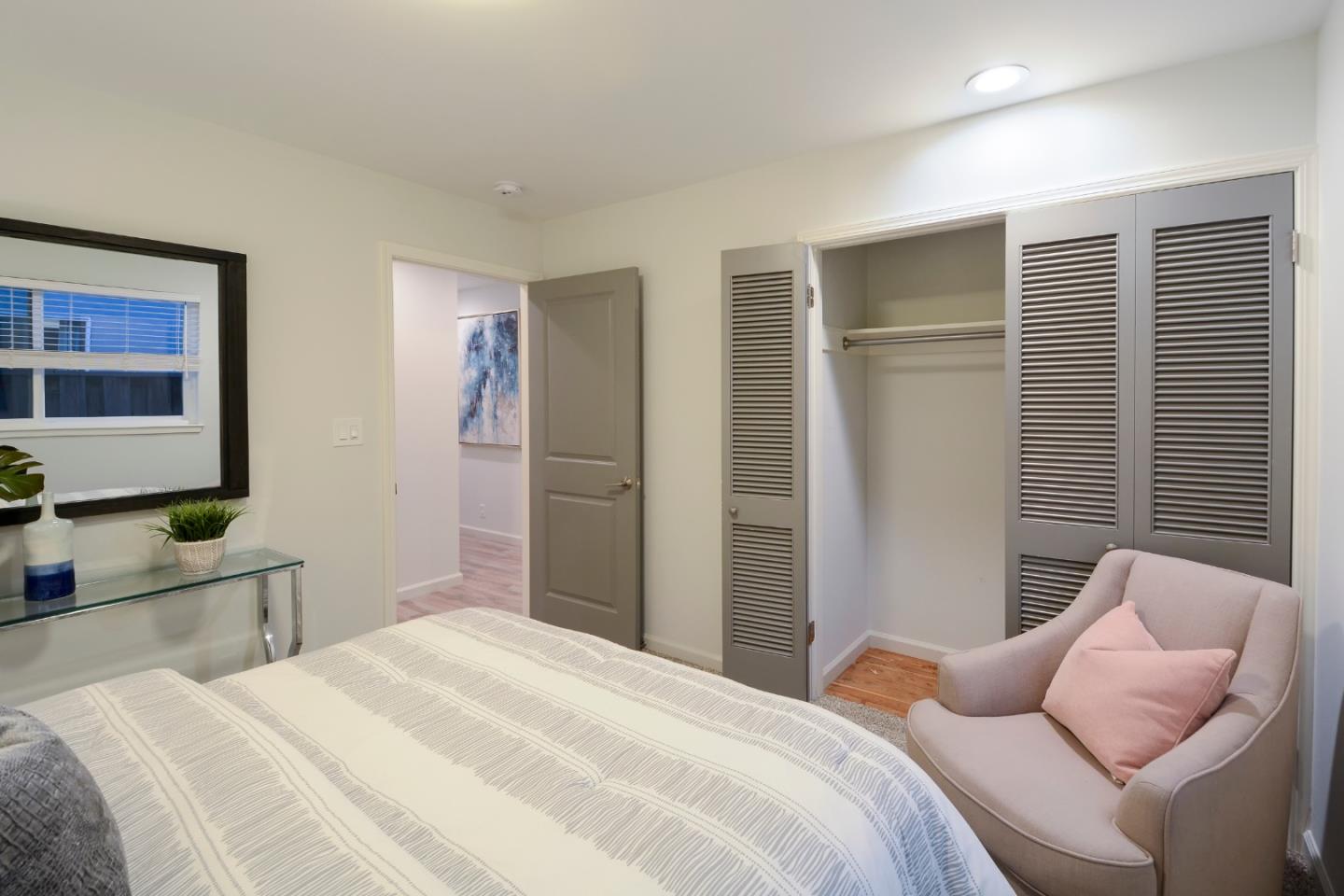 10166 Bonny Drive Cupertino, CA 95014 - Photo 22 of 46 a bedroom with furniture and a flat screen tv