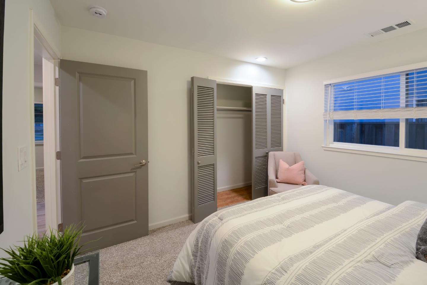 10166 Bonny Drive Cupertino, CA 95014 - Photo 23 of 46 a bedroom with a bed and a potted plant