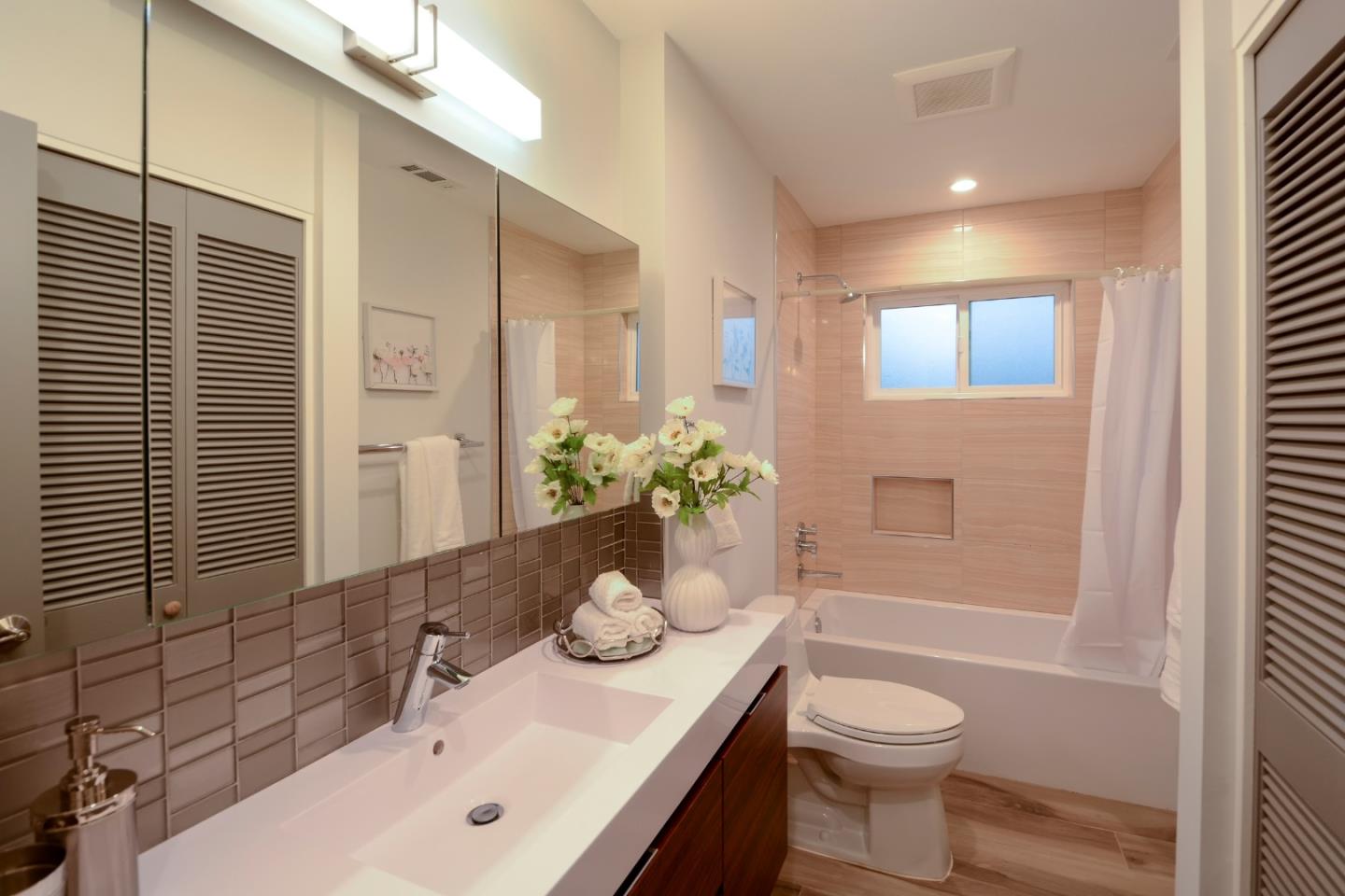 10166 Bonny Drive Cupertino, CA 95014 - Photo 28 of 46 a bathroom with a sink toilet and shower