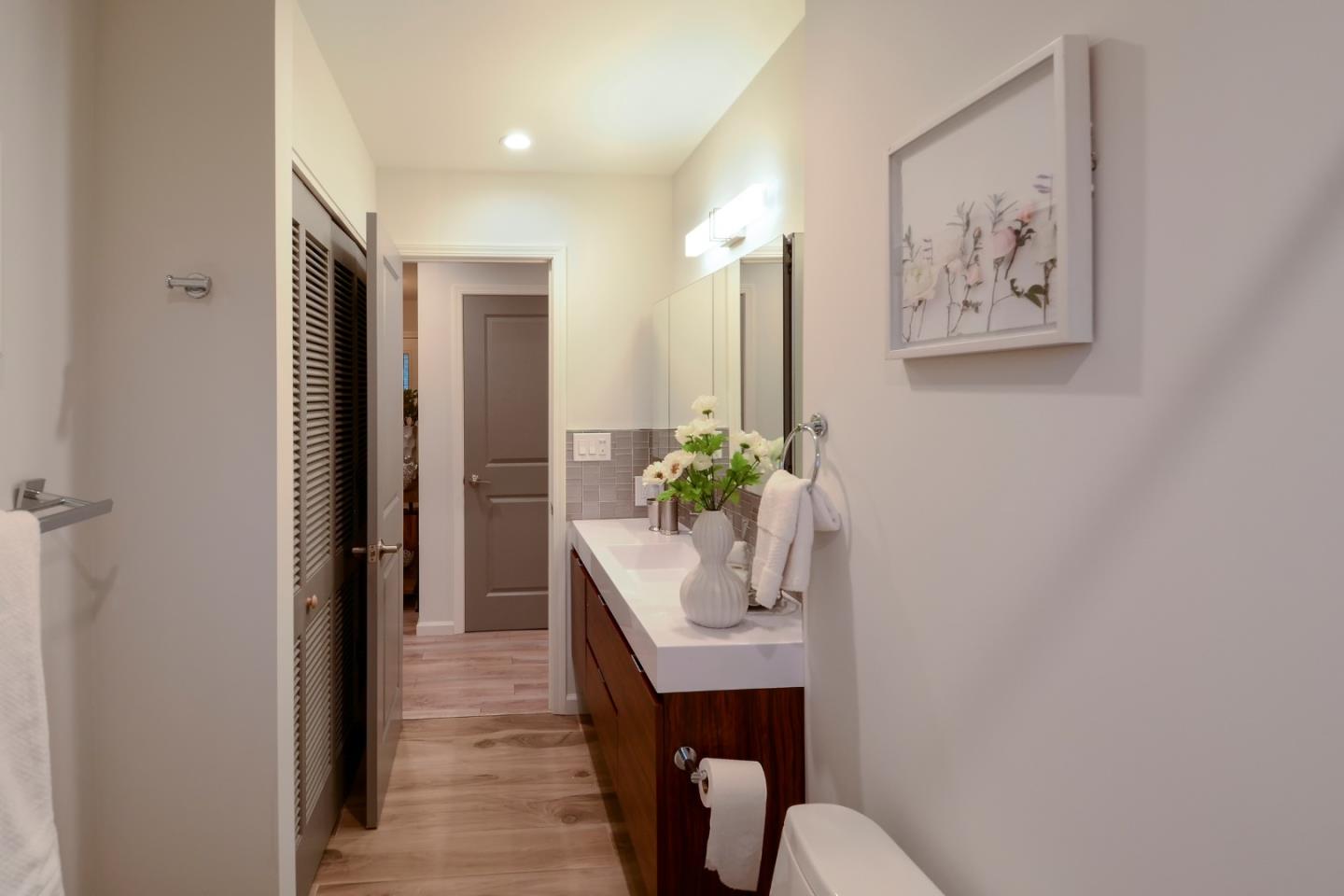 10166 Bonny Drive Cupertino, CA 95014 - Photo 29 of 46 a room with a painting on the wall and a potted plant