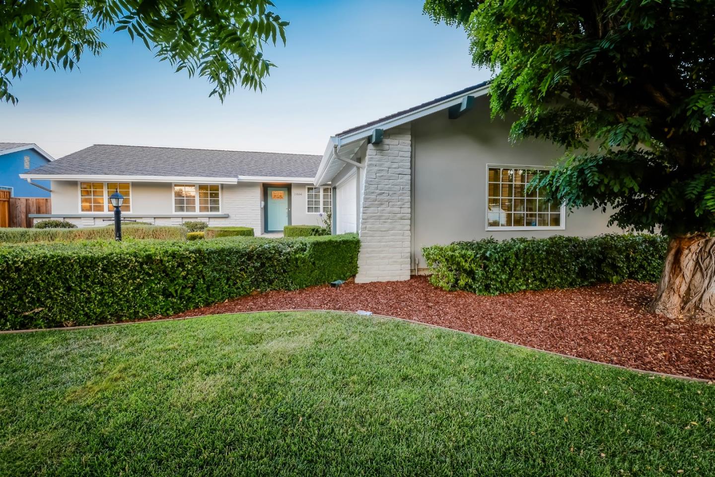 10166 Bonny Drive Cupertino, CA 95014 - Photo 3 of 46 a front view of a house with a garden