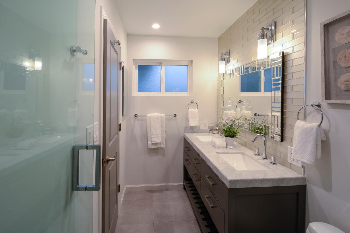 10166 Bonny Drive Cupertino, CA 95014 - Photo 31 of 46 a bathroom with a double vanity sink mirror and shower