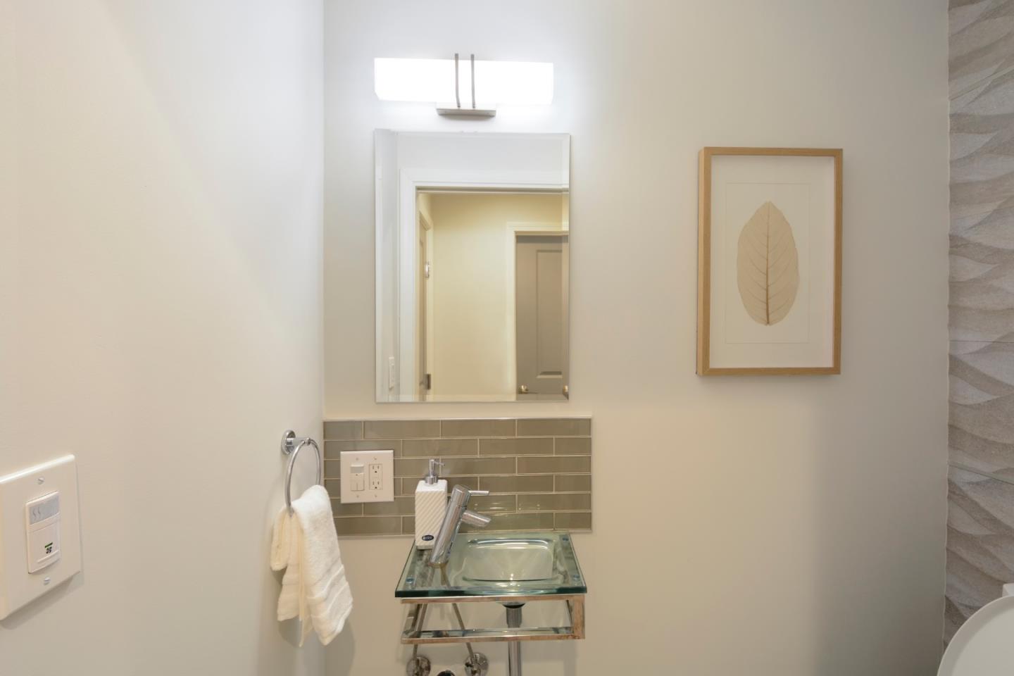 10166 Bonny Drive Cupertino, CA 95014 - Photo 32 of 46 a bathroom with a sink and a mirror