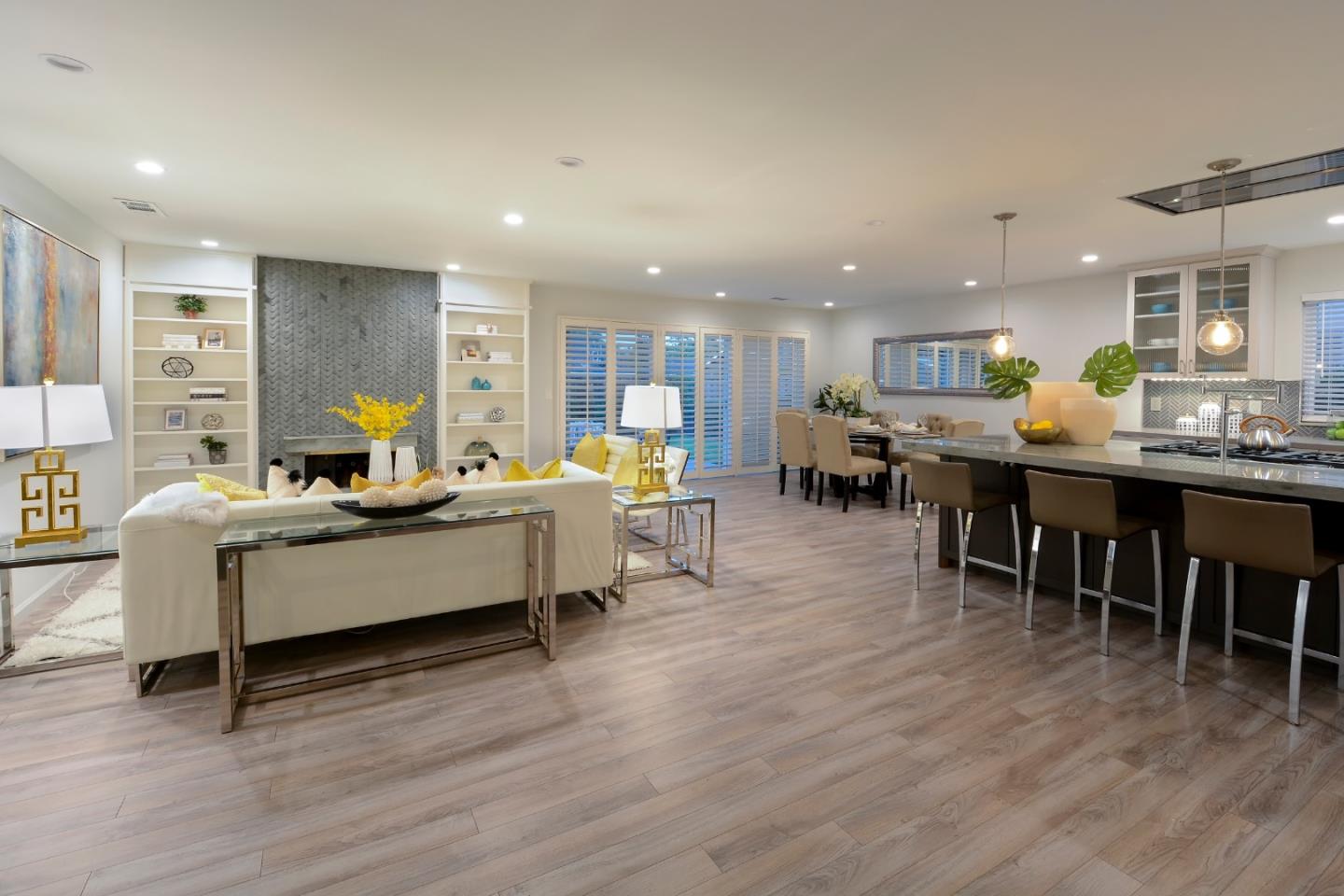 10166 Bonny Drive Cupertino, CA 95014 - Photo 10 of 46 a living room with stainless steel appliances kitchen island granite countertop wooden floor a dining table and chairs