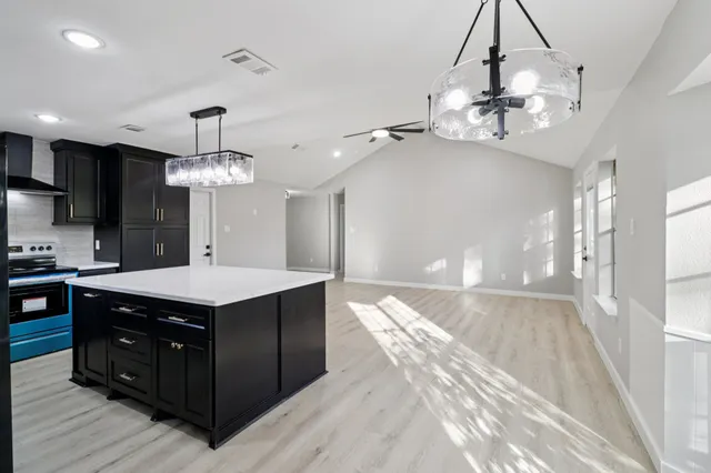 a kitchen with a counter space a sink and a stove