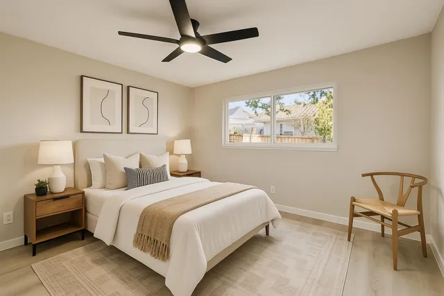 a bedroom with a bed a chair and a window