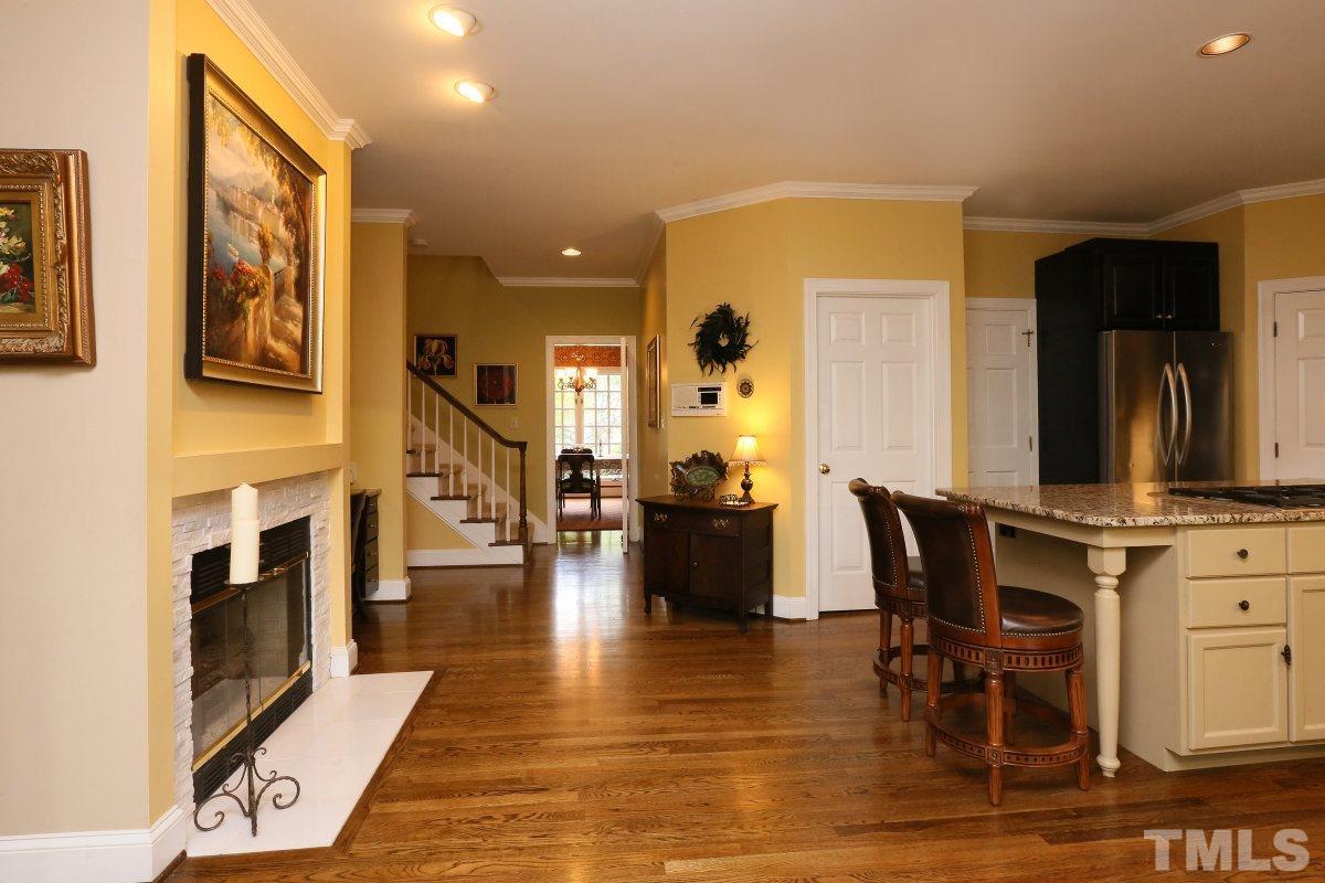 8801 Ashdown Court Raleigh, NC 27613 - Photo 14 of 25 Gas Fireplace into Kitchen