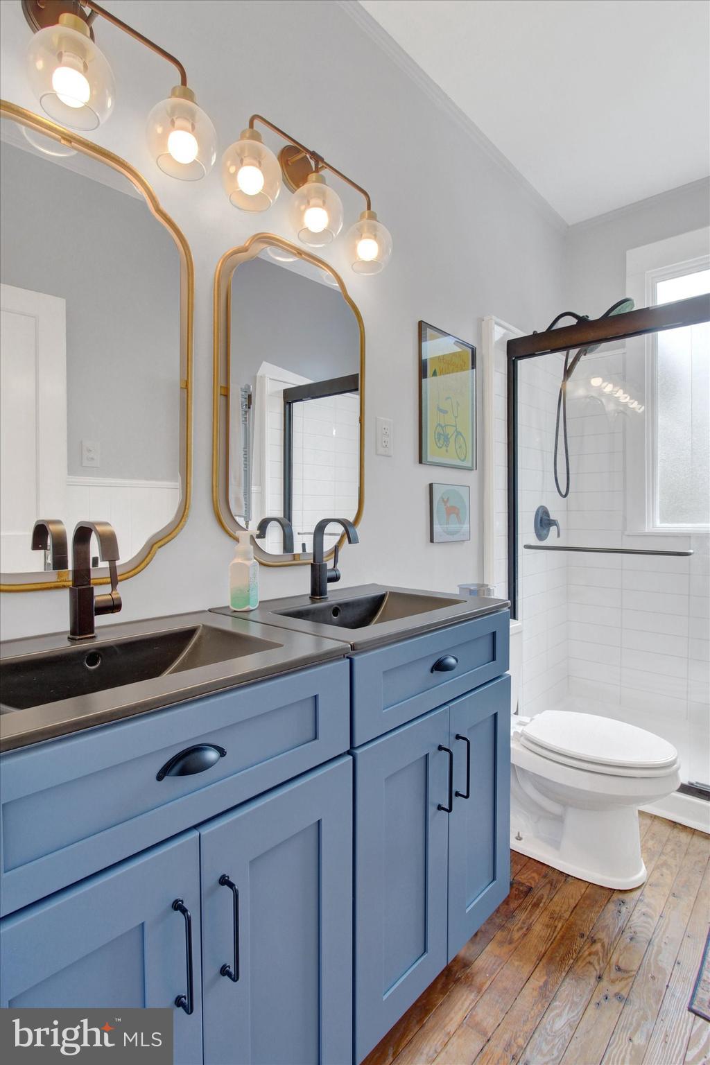 516 North Scott Street York, PA 17404 - Photo 9 of 22 a bathroom with a double vanity sink toilet and a mirror