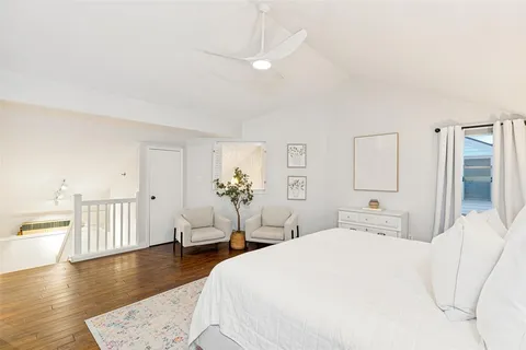 a bedroom with a white bed and white walls