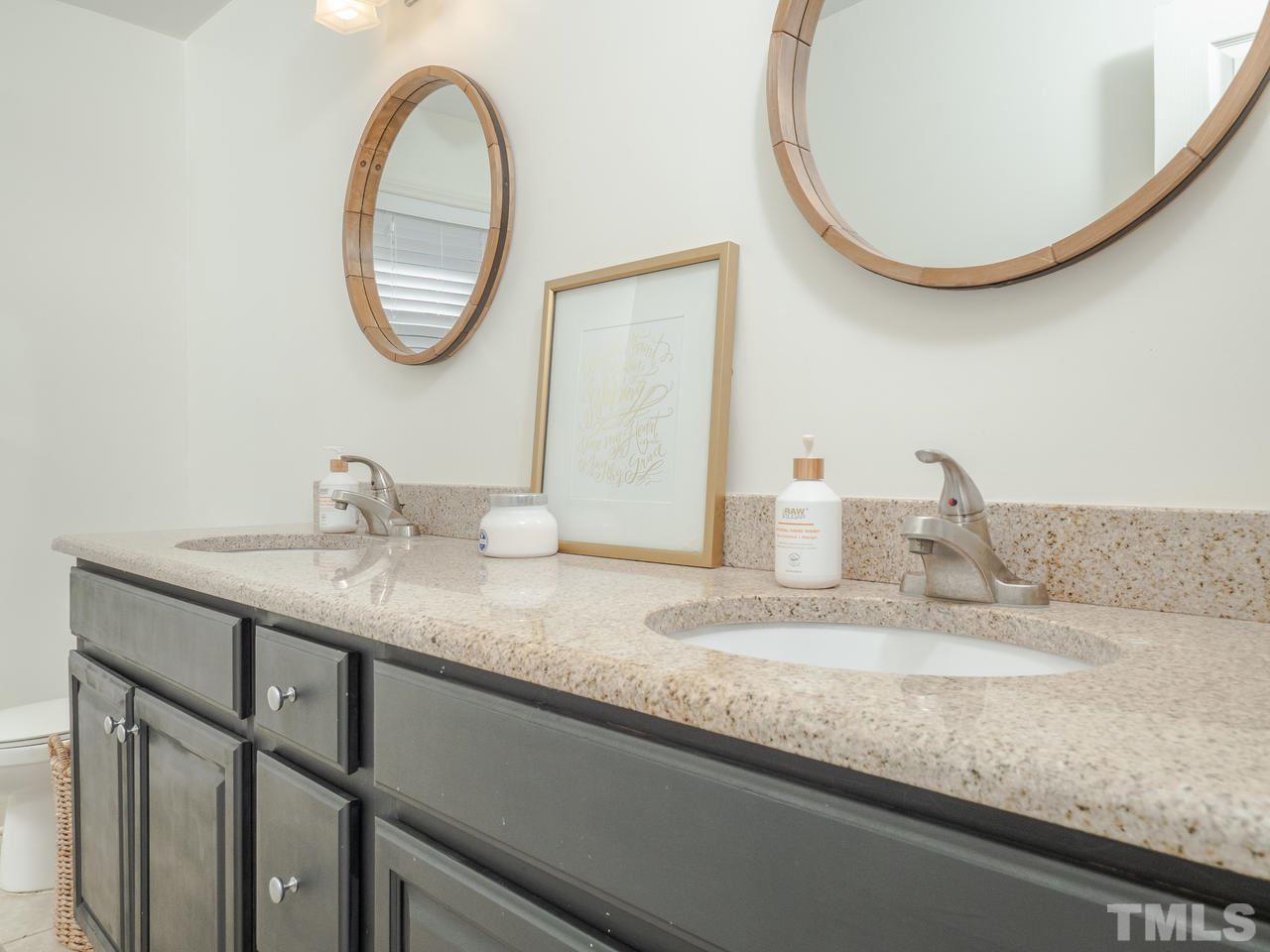 16 South Pettigrew Street Raleigh, NC 27610 - Photo 13 of 25 a bathroom with a granite countertop sink and a mirror