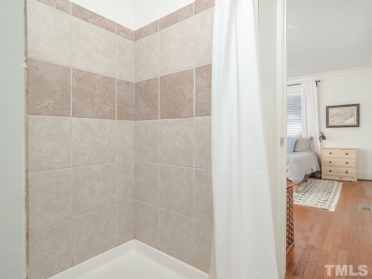 16 South Pettigrew Street Raleigh, NC 27610 - Photo 14 of 25 a bathroom with a bathtub and a toilet