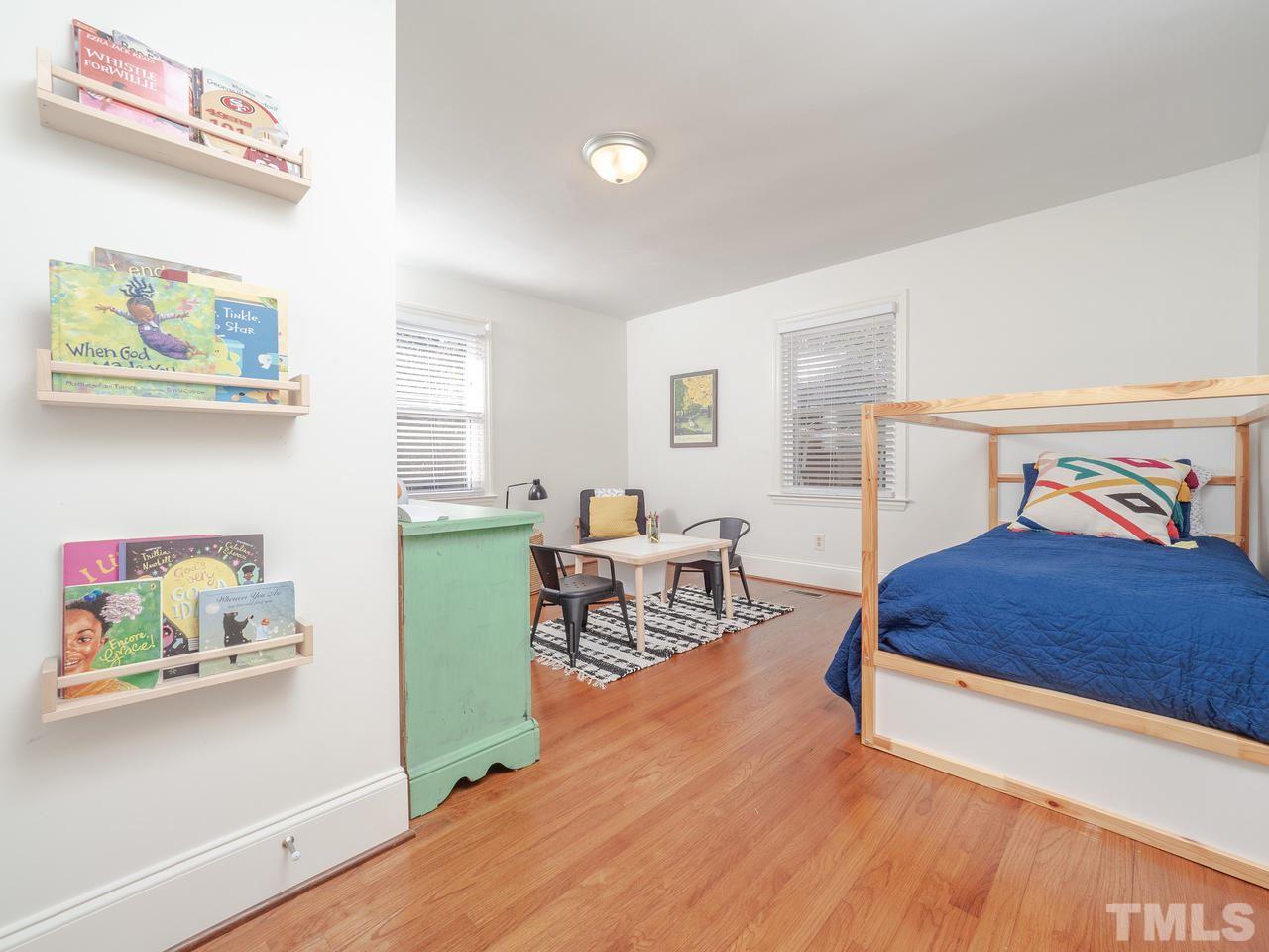 16 South Pettigrew Street Raleigh, NC 27610 - Photo 15 of 25 a bedroom with furniture and a wooden floor