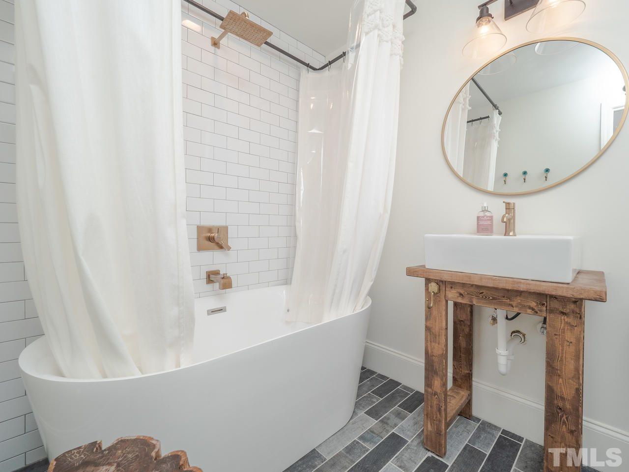 16 South Pettigrew Street Raleigh, NC 27610 - Photo 17 of 25 a bathroom with a sink a toilet and a mirror