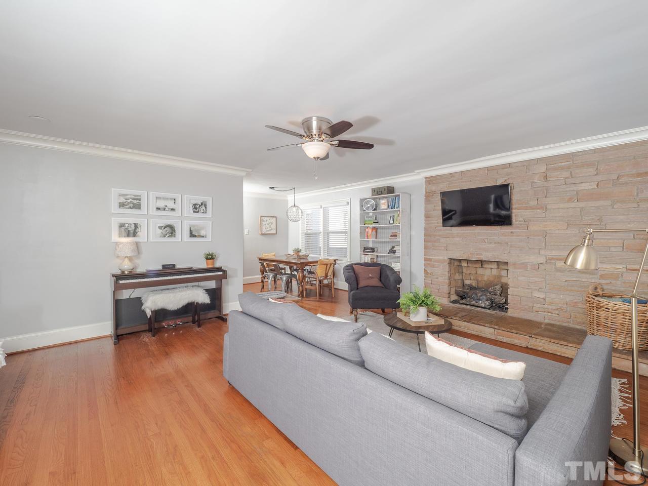 16 South Pettigrew Street Raleigh, NC 27610 - Photo 3 of 25 a living room with fireplace furniture and a wooden floor