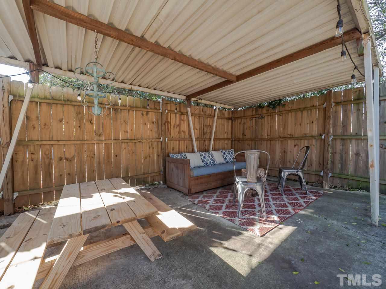 16 South Pettigrew Street Raleigh, NC 27610 - Photo 23 of 25 a view of a backyard with table and chairs