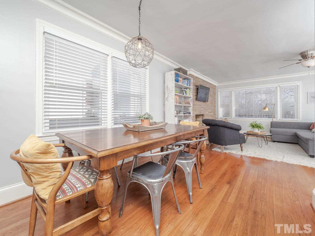 16 South Pettigrew Street Raleigh, NC 27610 - Photo 7 of 25 a dining room with wooden floor and large windows