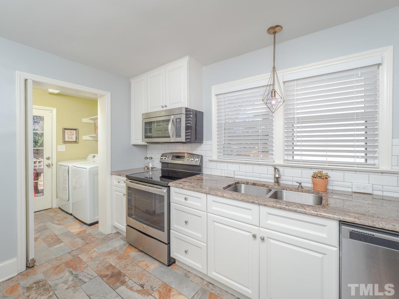 16 South Pettigrew Street Raleigh, NC 27610 - Photo 10 of 25 a kitchen with a sink stove and cabinets