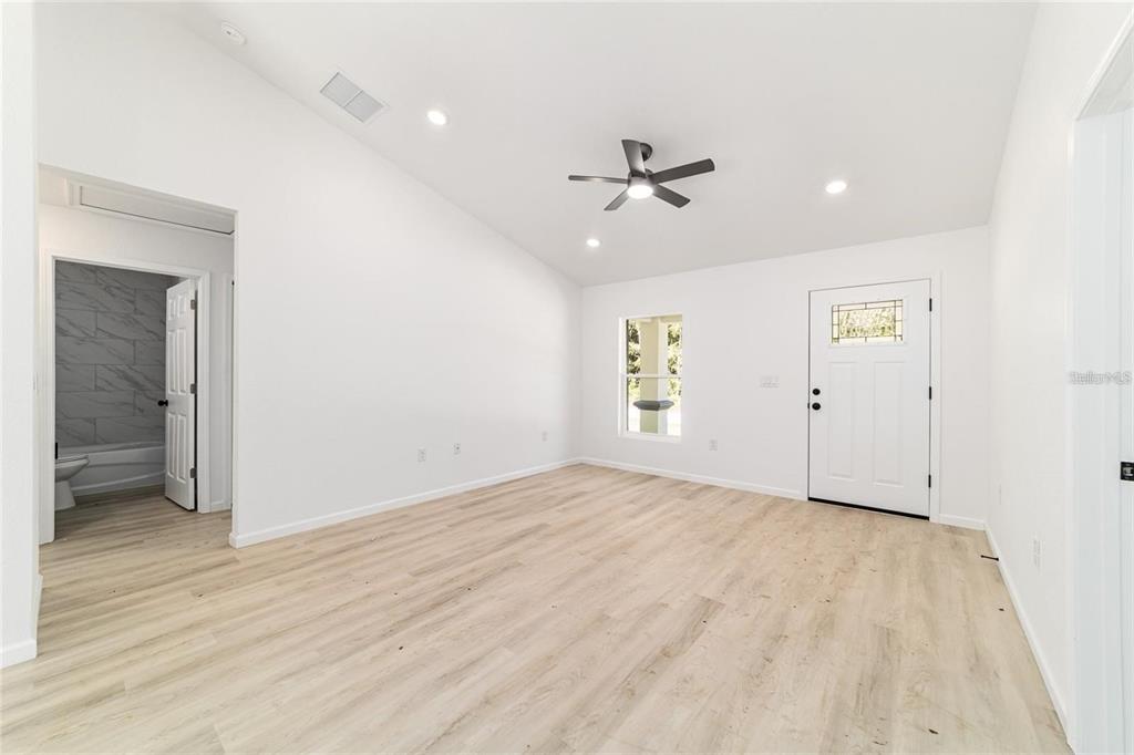 13310 Southwest 11th Street Road Ocala, FL 34481 - Photo 14 of 35 a view of empty room with wooden floor and fan
