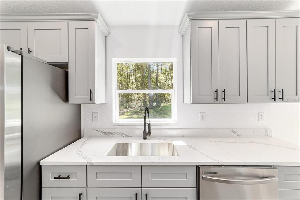 13310 Southwest 11th Street Road Ocala, FL 34481 - Photo 20 of 35 a kitchen with appliances cabinets and a sink