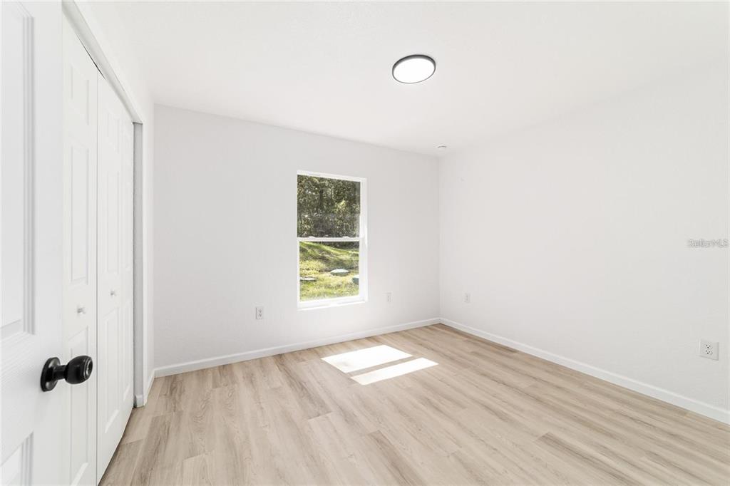 13310 Southwest 11th Street Road Ocala, FL 34481 - Photo 22 of 35 an empty room with wooden floor and windows